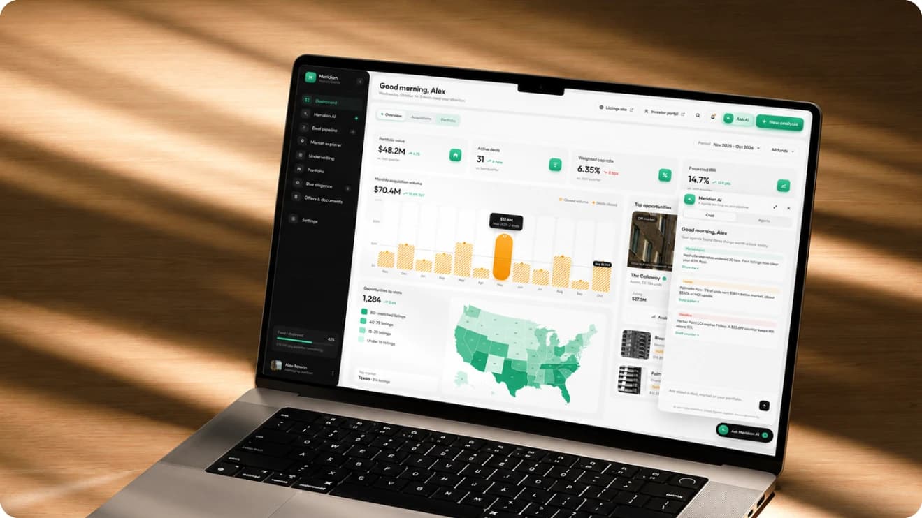 The Meridian home dashboard on a laptop, lit by sunlight on a wooden desk