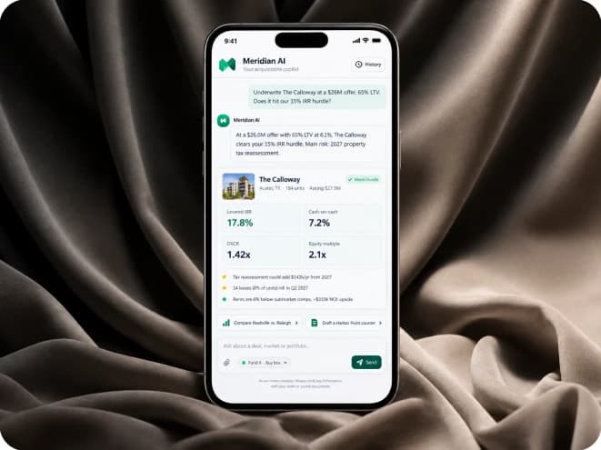 Meridian AI on a phone, underwriting The Calloway, resting on dark fabric