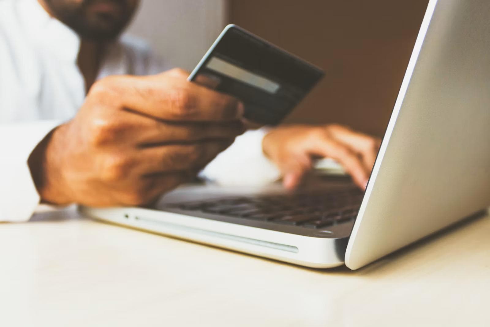 Someone paying by card on a laptop